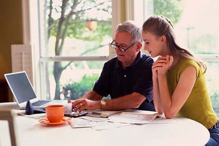 Father and daughter discussing finances